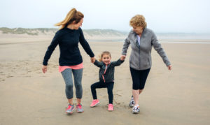 mother, daughter and grandmother on the beach