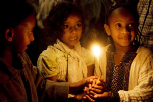 Ethiopian children lighting a candle in Jerusalem